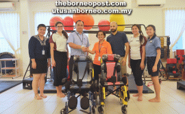 SOPB assistant head of support and services Joseph Ling Tiong Ing (third left) hands over the two new wheelchairs to a PDK Miri representative.