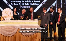 Taib (second left) cuts the SOP’s 50th anniversary cake together with Ling (third left). Also joining in the occasion are (from left) Raghad, Abang Johari, Paul Wong and Wong Soon Koh. — Photos by Chimon Upon