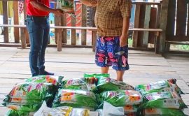 Estate Manager of SOP, Mr, Sumar Sariff handed over food aid to longhouse chieftain, Tr Baya Sipat.